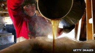 A woman pours maple syrup into a tank in Bowdoin, Maine (file image from 2006)