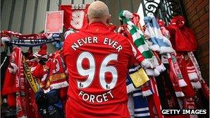 Liverpool supporter pays his respects at the Hillsborough Memorial at Anfield in 2009