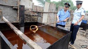 File photo: Police inspecting illegal cooking oil seized in 2010