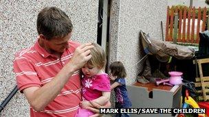 Father and daughter outside house