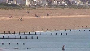 Bathers on the beach and in the sea at Shoreham