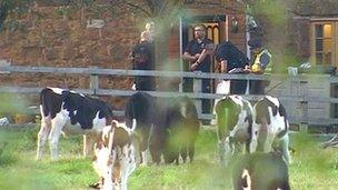 Police outside the farmhouse