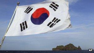 A South Korean flag flaps on a boat near islets called Dokdo in South Korea and Takeshima in Japan on 15 August, 2012