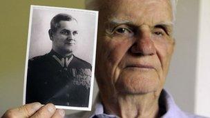 Franciszek Herzog holds a photograph of his father, also named Franciszek Herzog, in Hebron, Connecticut, US, on 7 September 2012