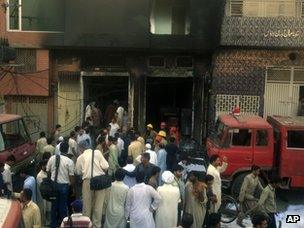 People gather outside the Lahore factory