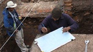 Mathew Morris (left) and colleague record the grave