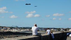 A family watching the Battle of Britain Memorial Flight