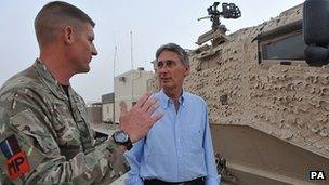 Sergeant Darryl Adams, from 2 Tactical Police Squadron talks to Defence Secretary Philip Hammond