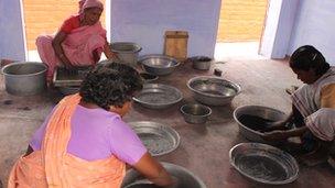 Women mixing explosive powders and chemicals by hand