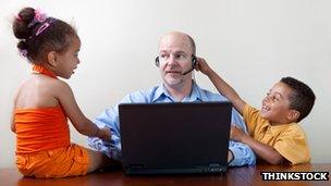 Man at home working with kids