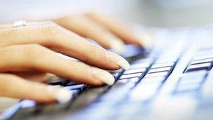 A woman using a computer keyboard