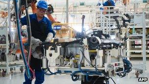 A worker on the floor of a car factory in China 16 August 2012