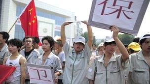 Workers at a plant of the Japanese company Meiko Electronics march with anti-Japan banners during a protest against Tokyo's plans to buy the disputed Diaoyu/Senkaku Islands on 18 September 2012.