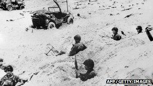 Soldiers of the Allied Expeditionary Corps stand sentry on a beach of Normandy in northern France during the June 1944 operations, after D-Day. Photo: AFP/Getty Images