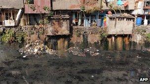 Dwellings overlooking sewer in Dharavi