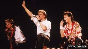 Left-right: John Taylor, Simon Le Bon and Andy Taylor on stage in 1984