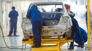 Workers on the floor of a car factory in China 16 August 2012