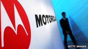 Man walks past Motorola sign