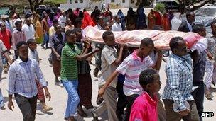 People attend the funeral of one of those killed in the Village restaurant bombing - 21 September 2012