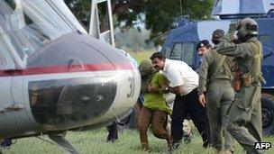 Pakistani security personnel shift Rimsha Masih (L), a Christian girl accused of blasphemy, to a helicopter after her release from jail in Rawalpindi