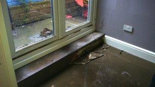 Flooring has been ruined, and a coating of sediment left covering all flat surfaces that the floodwaters touched