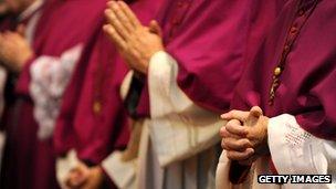 German bishops fold their hands as they attend the opening service for a plenary meeting of the German Conference of Catholic Bishops