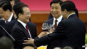 Chinese Premier Wen Jiabao, standing left, makes a toast with high-ranking Chinese officials during a dinner marking the 63rd anniversary of the founding of the People's Republic of China at the Great Hall of the People in Beijing Saturday, 29 September 2012