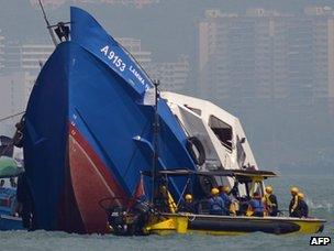 The bow of the Lamma IV boat (L) is seen partially submerged during rescue operations on 2 October