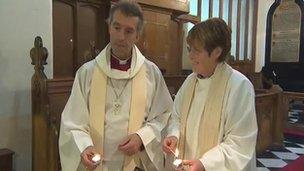 Bishop of Bangor, Andy John, with Revd Kathleen Rogers, priest-in-charge, lighting candles at a vigil for April Jones at St Peter’s Church, Machynlleth, on Wednesday