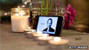 Candles and flowers placed outside Apple Store in New York