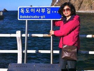 A South Korean tourist poses for a picture on the disputed Dokdo/Takeshima islands, 04 Oct 2012