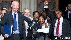 Lawyer Martyn Day (l) and supporters of a group of Kenyans who allege abuse by British colonial authorities celebrate as they leave the High Court