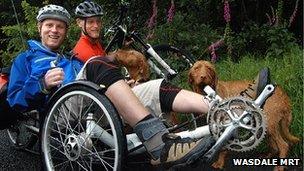 Joe Beaumont (L) and twin brother John and their two dogs