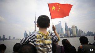 People stroll on the Bund, a famous waterfront in Shanghai, 03 Oct 2012