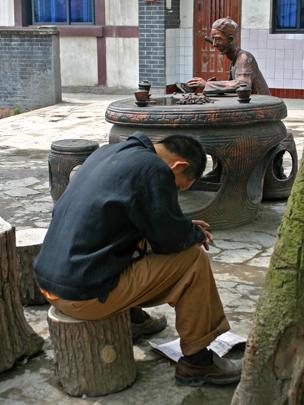 Man sitting on his own in square