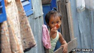 Cambodian girl looking out of a window