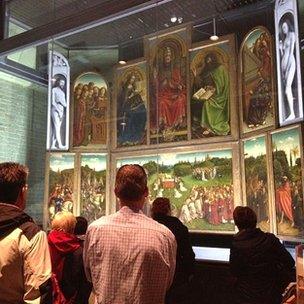 Tourists look at the altarpiece