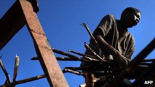 Haitian worker loading cut sugar cane on a plantation in Dominican Republic