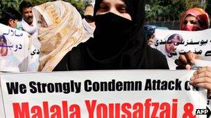 Peace activists carry photos of gunshot victim Malala Yousafzai during a protest rally against her assassination attempt, in Peshawar 10 October, 2012.