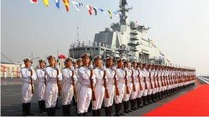 Naval honour guards stand as they wait for a review on China"s aircraft carrier "Liaoning" in Dalian, Liaoning province, September 2012