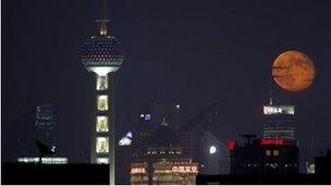 Moon rising over Shanghai - archive image