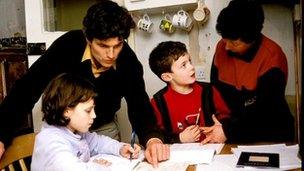 A family does homework in kitchen