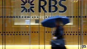 A woman walks past an RBS branch