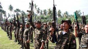 Moro Islamic Liberation Front (MILF) rebels raising their rifles during during a ceremony in Mindanao, 14 October 2012