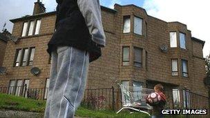 Children playing by boarded-up houses