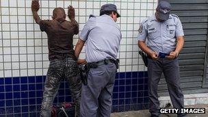 Military policemen frisk a suspect in downtown Sao Paulo