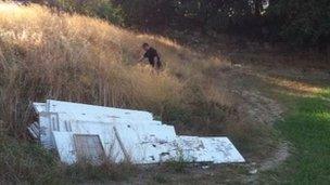 Police officer with a dog searching near the house