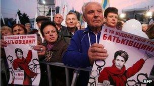 People hold placards depicting Ukrainian opposition leader Yulia Tymoshenko at an opposition rally in Donetsk