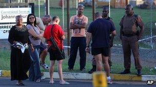 Correctional services staff gather inside the prison south of Johannesburg Monday, Oct. 22, 2012.