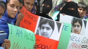 Pakistani students carry placards with the photograph of child activist Malala Yousafzai